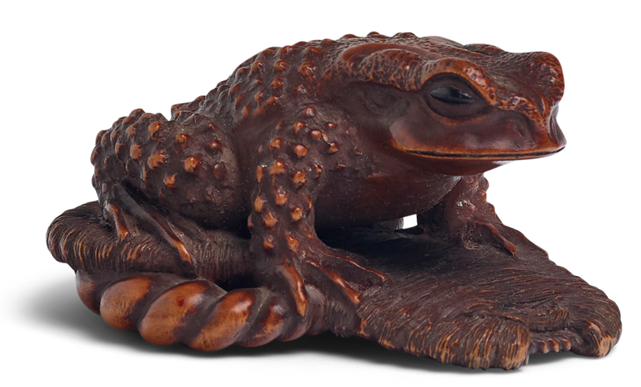 MASANAO (ISE, ACTIVE 19TH CENTURY) A Wood Netsuke of a Toad on a Sandal Edo period (1615-1868), 19th century. Estimate: $1,500 - $2,000