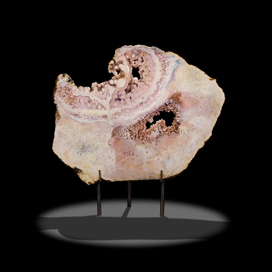 Lot 2267. Giant Rose Quartz Slab with Druzy Pierced Cavities. Estimate: $2,500 - $3,500