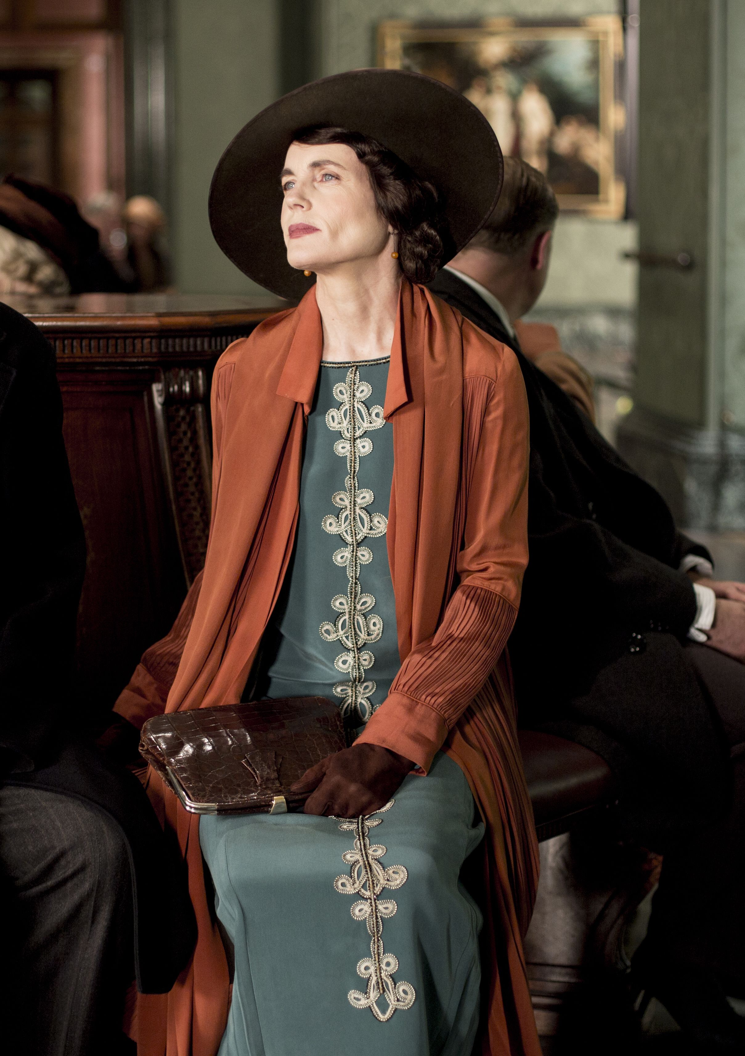 Elizabeth McGovern (as Cora, Countess of Grantham): A Teal Dress with Terracotta Pleated Coat Season 5, Episode 3. Estimate £2,000-3,000