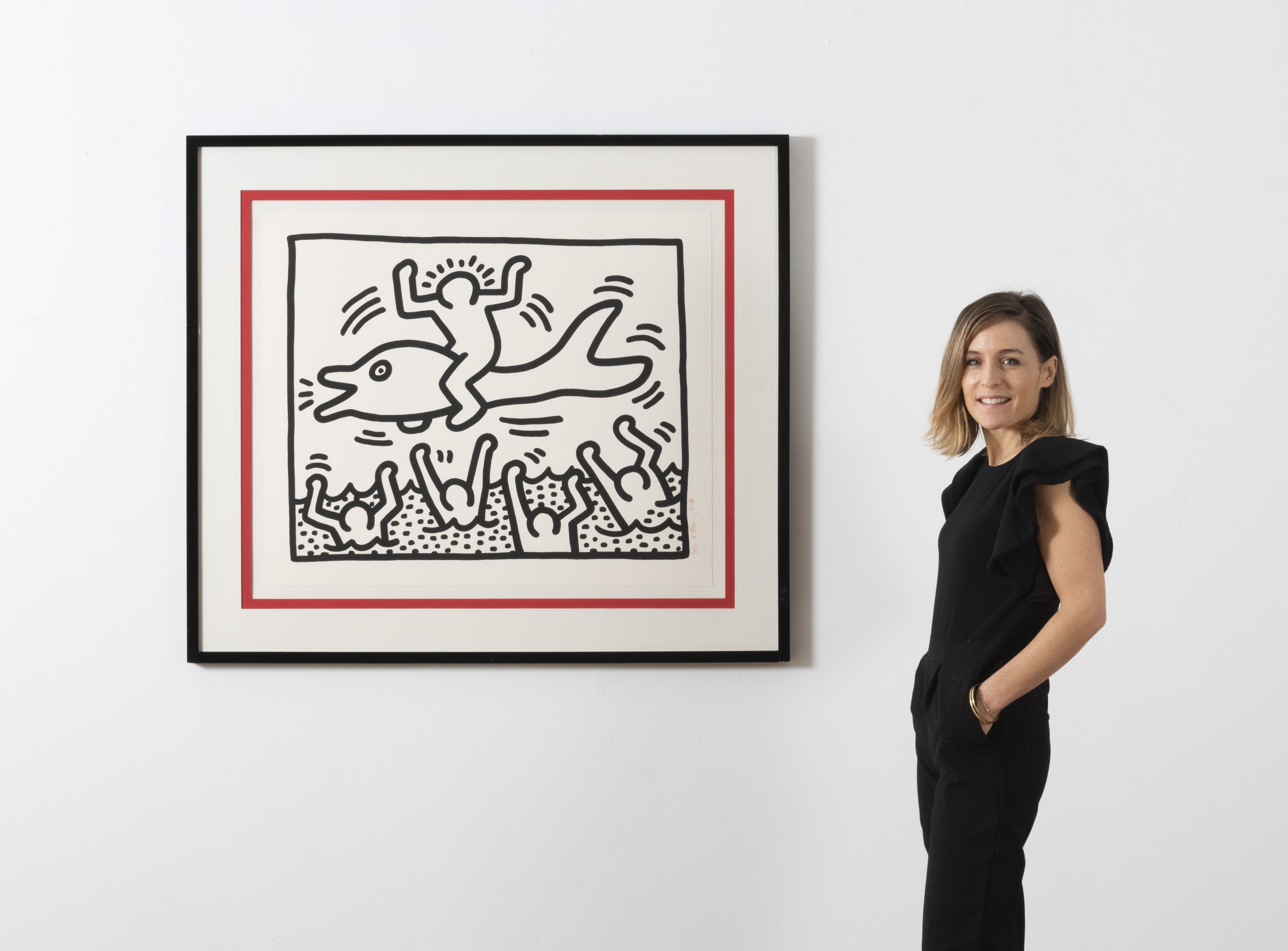 Valentine Naslin with Keith Haring's Untiltled (Man on Dolfin), 1987. Estimate: €20,000 - €30,000.