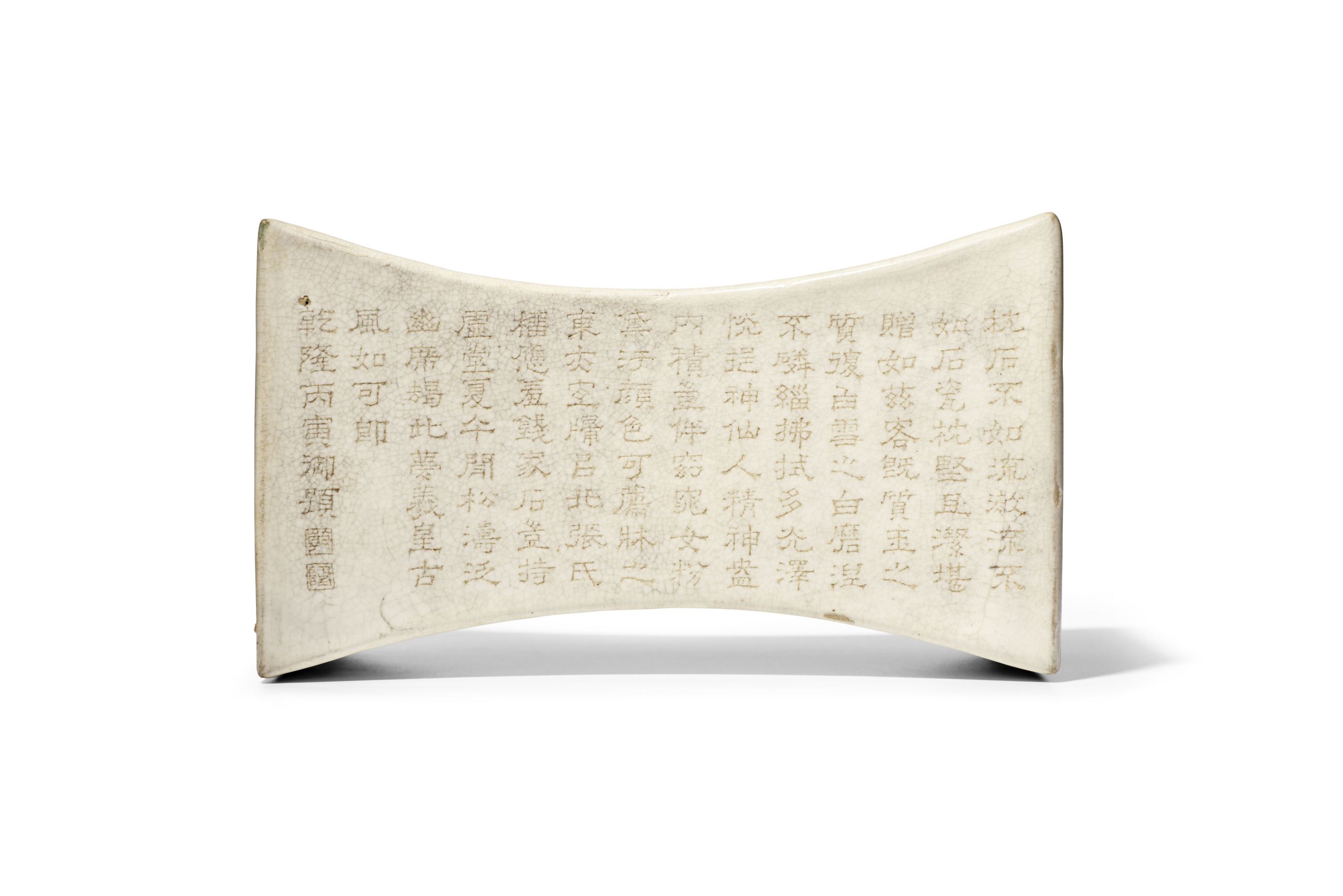 A Rare Imperially-Inscribed White-Glazed Ingot-Shaped Pillow. The pillow Song Dynasty (960-1279), the inscribed poem dated 1746. Sold for $882,312.