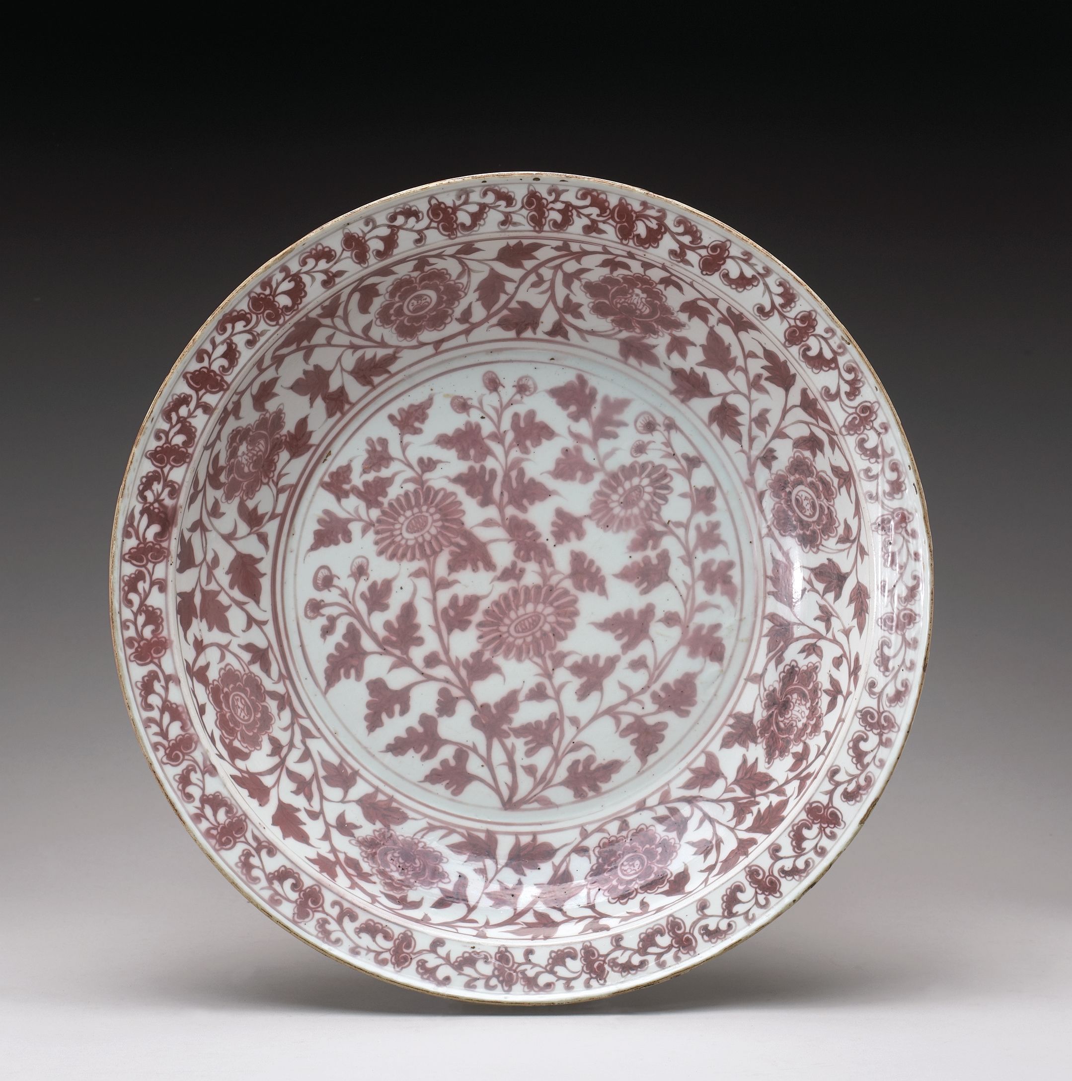 A rare and important underglaze copper red decorated dish. Sold for $5,726,250 inc. premium.