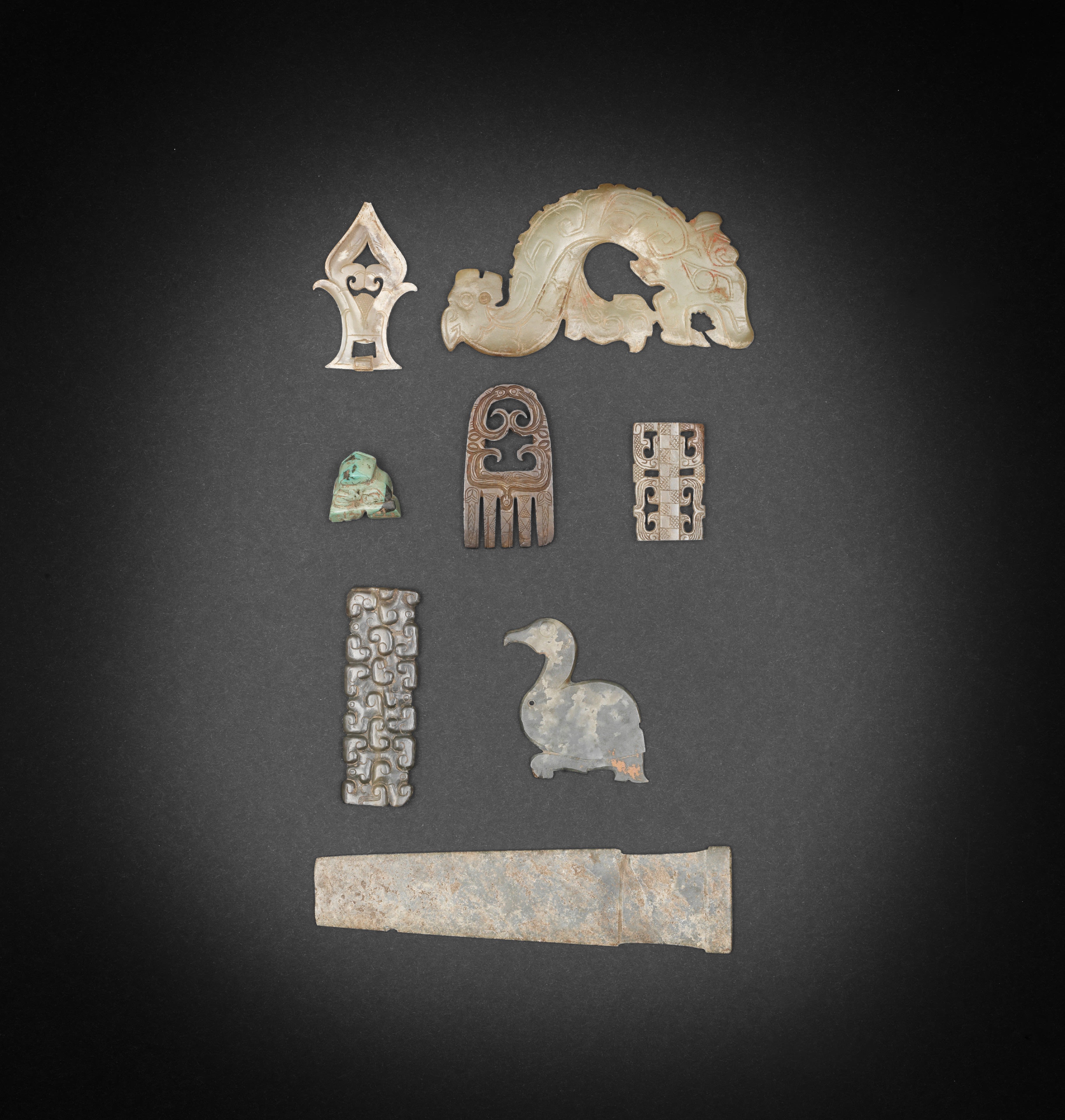 Seven Early Jade Carvings Together with a Turquoise Carving of a Bovine Beast-Head, Shang/Han Dynasty, Sold For £ 437,750 Inc. Premium.